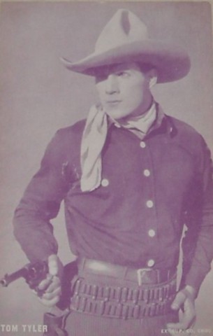 Tom Tyler posing with gun blue arcade card